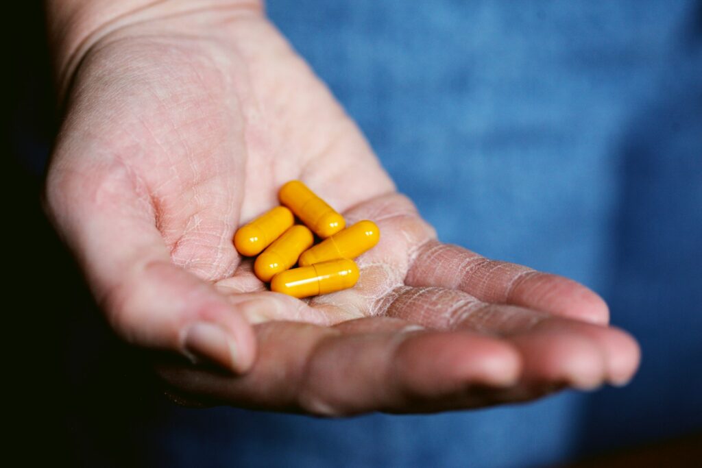 A man holds a handful of meds for depression and anxiety in Florida