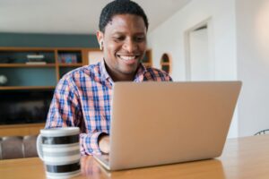 A man smiles as he completes a virtual therapy meeting in conjunction with ADHD treatment medication in Orlando